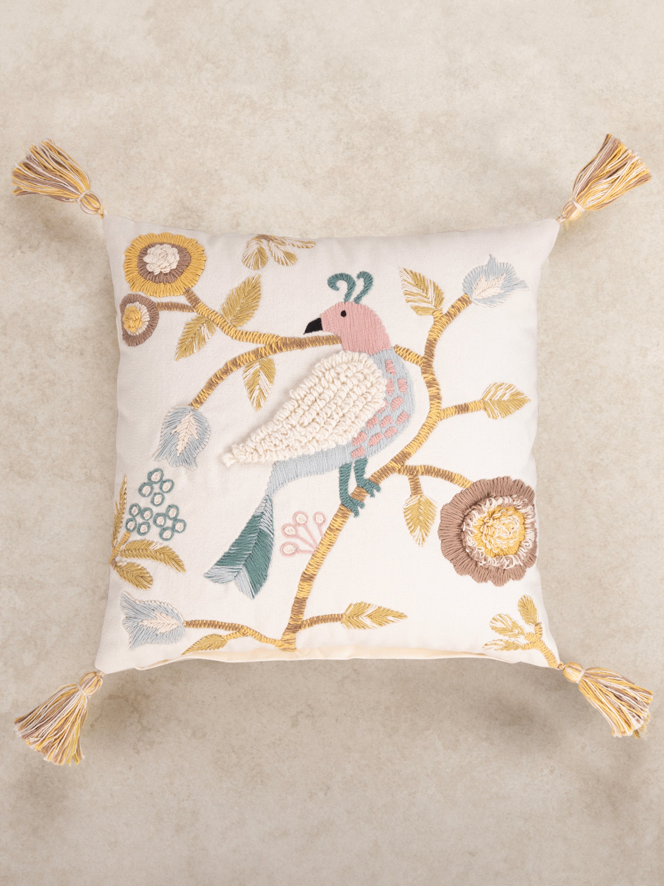 Bohemian-Inspired Embroidered Cushion with Elegant Bird & Floral Design – A stylish throw pillow showcasing detailed hand-stitching of a bird and botanical motifs, set against a neutral fabric for a timeless aesthetic