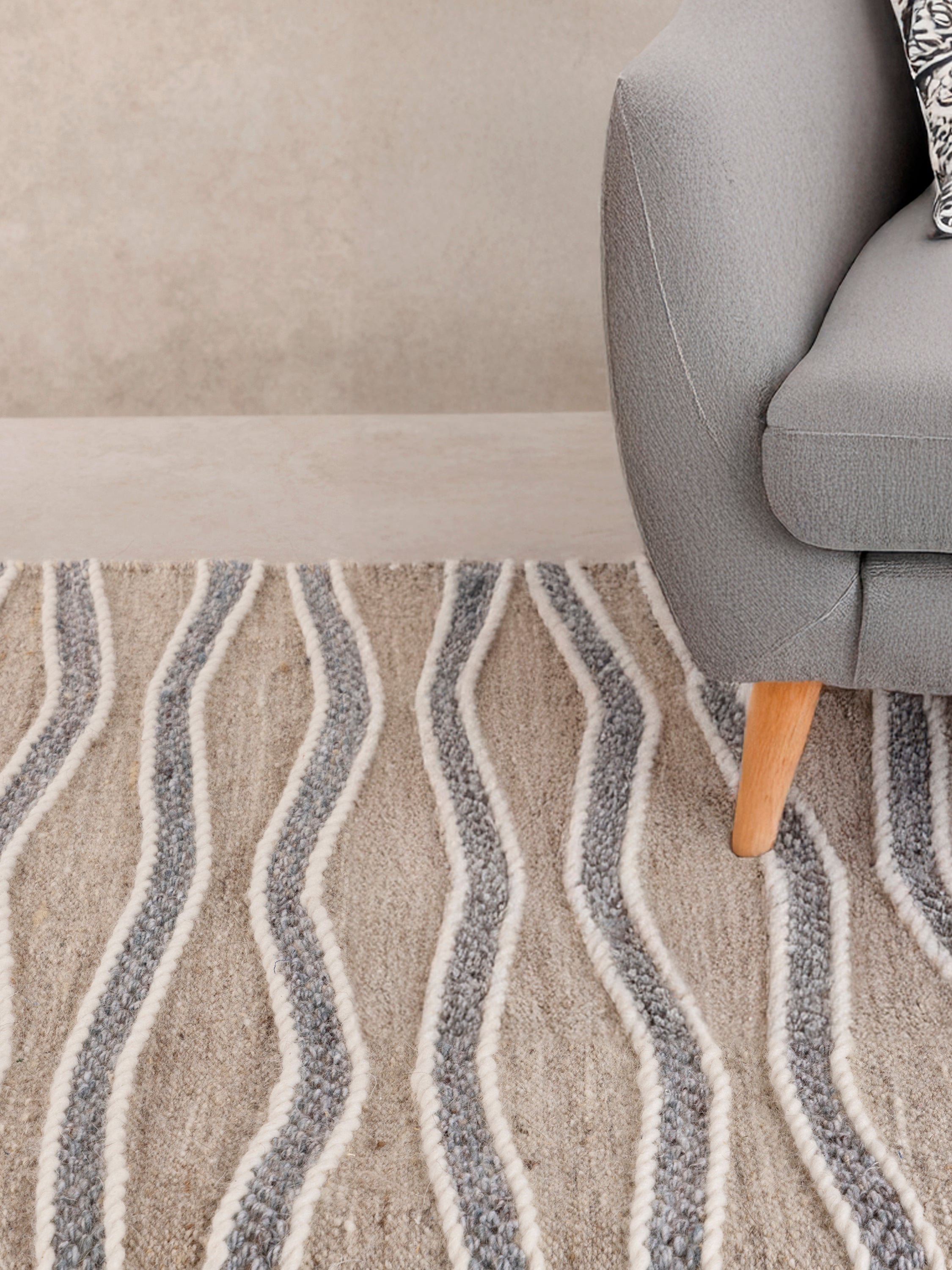 Eco-friendly beige and gray wool-jute blend area rug featuring a flowing wave design