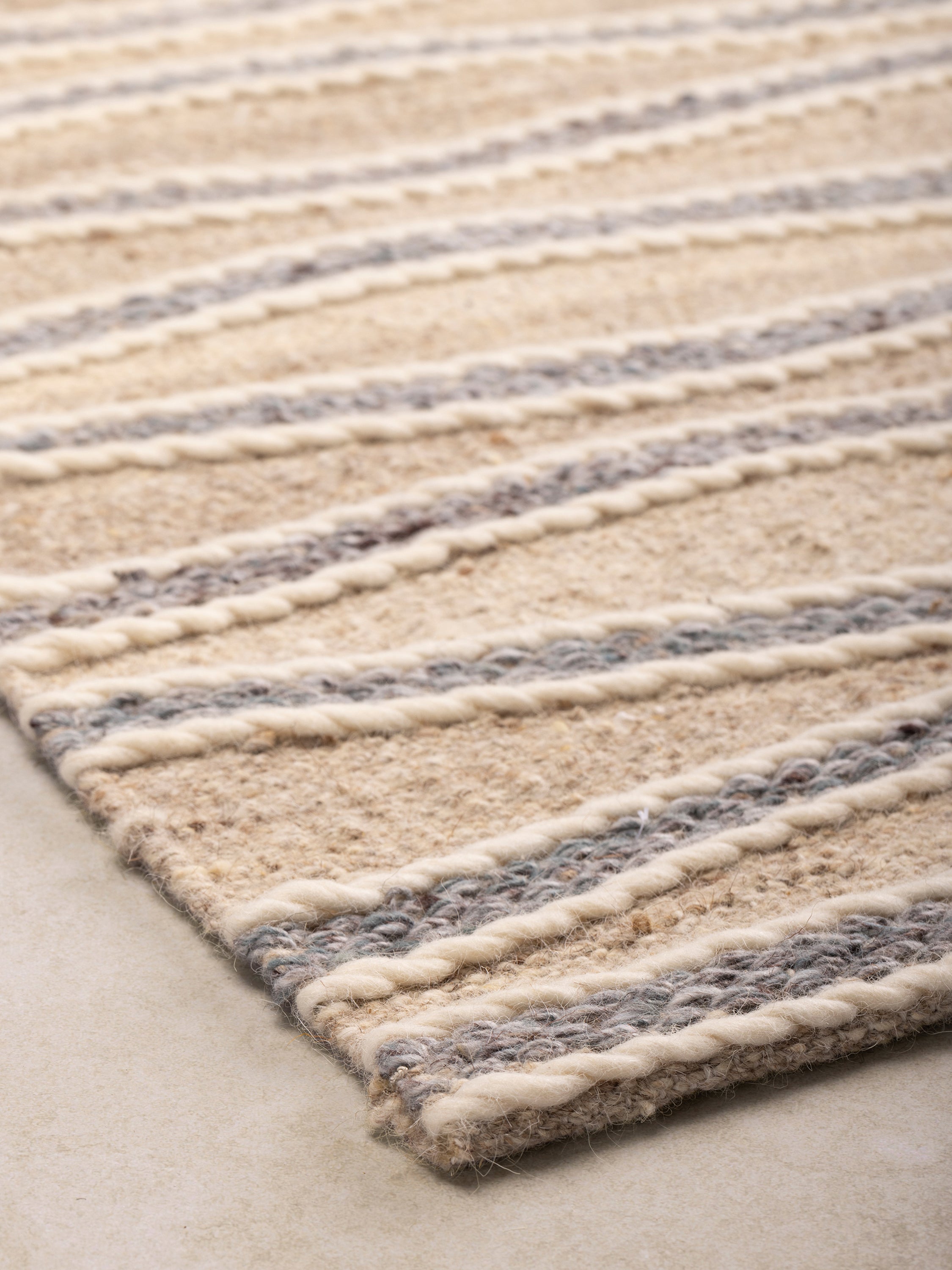 Contemporary flatweave rug with textured wave patterns, perfect for minimalist and coastal decor